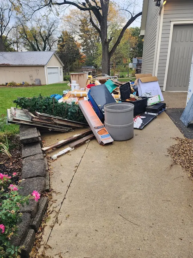 Dumpster being loaded with debris for Residential Dumpster Rental in Riviera Beach